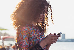 Person sending text on smart phone